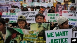 FILE - Rohingya refugees living in India hold placards during a protest in New Delhi demanding an end to the violence against ethnic Rohingyas in Myanmar's Rakhine state, March 11, 2015. 