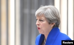 FILE - Britain's Prime Minister Theresa May makes a statement in Downing Street after traveling to Buckingham Palace to ask the Queen's permission to form a minority government, in London, June 9, 2017.