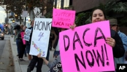 Demonstrators urging the Democratic Party to protect the Deferred Action for Childhood Arrivals Act (DACA) rally outside the office of California Democratic Sen. Dianne Feinstein in Los Angeles, Jan. 3, 2018. 