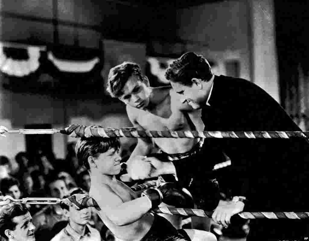 Mickey Rooney is against the ropes as Spencer Tracy stands by him in this scene from the 1938 movie &quot;Boys Town.&quot;&nbsp;