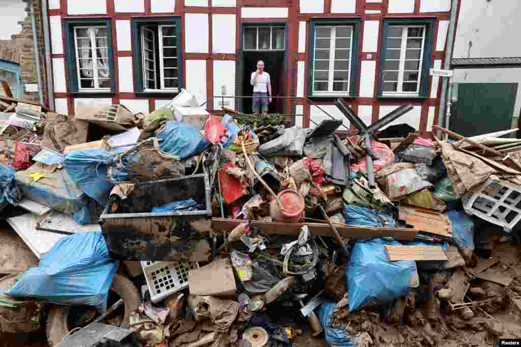 A man is seen outside a house in an area affected by floods caused by heavy rainfalls in Bad Muenstereifel, Germany.