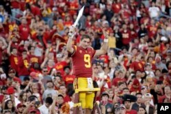 FILE - Southern California quarterback Kedon Slovis (9) directs the school's band after a 52-35 win over UCLA in an NCAA college football game, Saturday, Nov. 23, 2019, in Los Angeles. (AP Photo/Marcio Jose Sanchez)