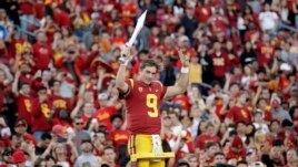 FILE - Southern California quarterback Kedon Slovis (9) directs the school's band after a 52-35 win over UCLA in an NCAA college football game, Saturday, Nov. 23, 2019, in Los Angeles. (AP Photo/Marcio Jose Sanchez)