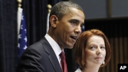 U.S. President Barack Obama and Australian Prime Minister Julia Gillard speak at a joint news conference at Parliament House in Canberra, Australia, November 16, 2011.