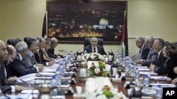 Palestinian Prime Minister Salam Fayyad speaks to his cabinet members after a meeting in the West Bank city of Ramallah, February 14, 2011