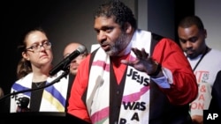The Rev. Dr. William J. Barber II, center, and Rev. Dr. Liz Theoharis, left, co-chairs of the Poor People's Campaign, speak at the National Civil Rights Museum in Memphis, Tennessee, April 3, 2018.