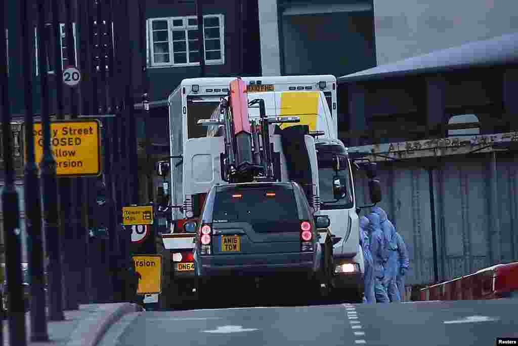 A white van which attackers used to ram into pedestrians on London Bridge is carried away, June 4, 2017.