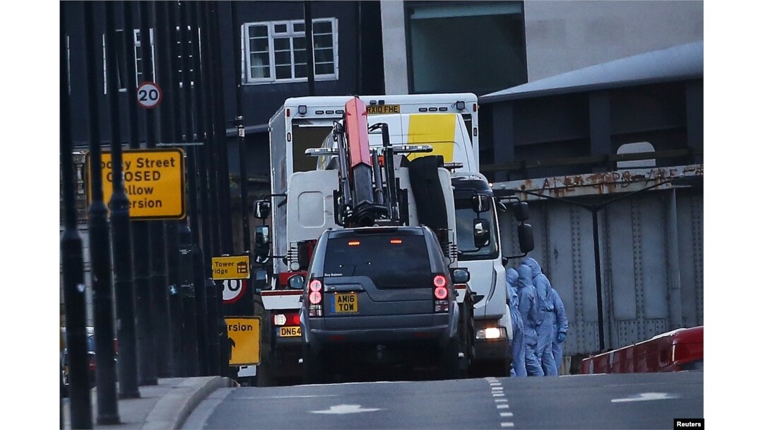 FILE - Forensics investigators work as a white van is carried away from London Bridge, after attackers rammed a hired van into pedestrians on London Bridge and stabbed others nearby killing and injuring people, in London, Britain, June 4, 2017.