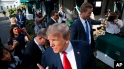 President Donald Trump speaks to reporters on the North Lawn of the White House, June 15, 2018, in Washington.