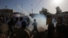 Supporters of Iraqi cleric Moqtada al-Sadr flee the tear gas fired by security forces during clashes after demonstrators broke into Baghdad's fortified "Green Zone" on May 20, 2016. 