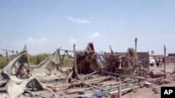 This still image taken from video shot Sept. 28, 2015, shows destruction to buildings after an airstrike hit a wedding party in al-Wahga, a village near the strategic Strait of Bab al-Mandab, Yemen. 