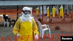 Medicins Sans Frontieres (MSF) health workers prepare at ELWA's isolation camp during the visit of Senior United Nations (U.N.) System Coordinator for Ebola David Nabarro, at the camp in Monrovia Aug. 23, 2014.