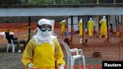 Medicins Sans Frontieres (MSF) health workers prepare at ELWA's isolation camp during the visit of Senior United Nations (U.N.) System Coordinator for Ebola David Nabarro, at the camp in Monrovia Aug. 23, 2014.