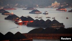 FILE - Coal barges are pictured as they queue to be pull along Mahakam river in Samarinda, East Kalimantan province, Indonesia, August 31, 2019. (REUTERS/Willy Kurniawan)