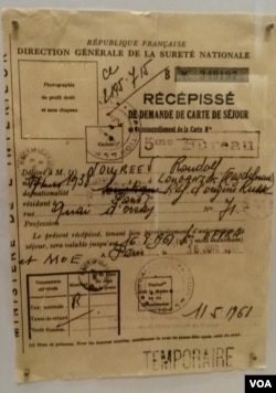 On display is the yellowed visa French authorities gave to star Soviet dancer Rudolph Nureyev when he defected to the West in 1961. (L. Bryant/VOA)