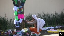 A man takes a moment to read some of the get well wishes and messages outside Nelson Mandela's house in Johannesburg, South Africa, July, 4, 2013.