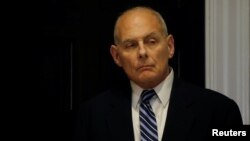 White House Chief of Staff John Kelly listens as President Donald Trump holds a round table meeting with members of law enforcement about sanctuary cities in the Roosevelt Room at the White House in Washington, March 20, 2018. 