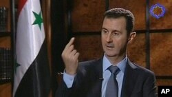 In this image taken from TV Syria's president Bashar al-Assad speaks during an interview in Tehran, Iran, Thursday June 28, 2012. Assad told Iranian state TV Thursday that his country still supports him, and he warned that any intervention in Syria will c