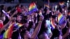 Fans waive rainbow flags in honor of LGBT Pride month in Los Angeles, June 2, 2018.