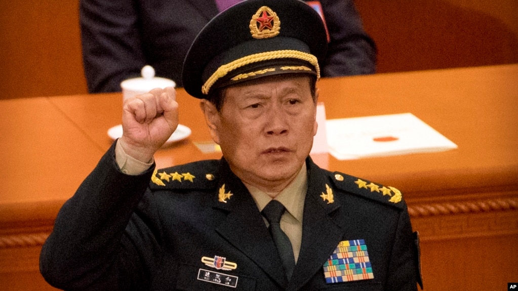 Newly-appointed defense minister Lt. Gen. Wei Fenghe takes the oath of office during a plenary session of China's National People's Congress (NPC) at the Great Hall of the People in Beijing, Monday, March 19, 2018. China on Monday appointed a former missile force commander as its new defense minister amid lingering concerns over the goals of its rapid military modernization. (AP Photo/Mark Schiefelbein)