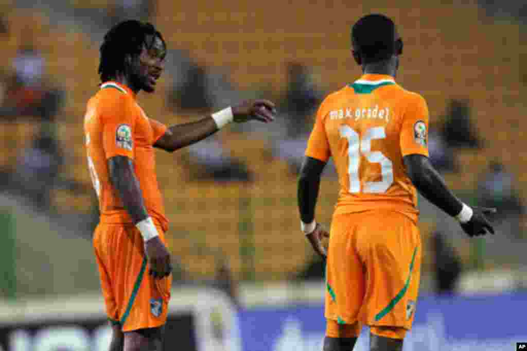 Jean-Jacques gives instructions to Max Alain of Ivory Coast during their African Nations Cup soccer match against Burkina Faso in Malabo