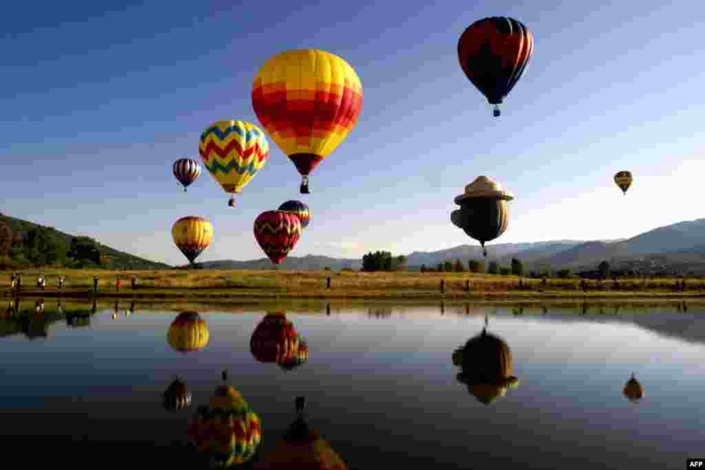 Balloons fly in the sky during the 36th Annual Hot Air Balloon Rodeo in Steamboat Springs, Colorado, July 9, 2017.