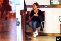 A relative of the victims of the EgyptAir flight 804 that crashed, reacts as she makes a phone call at Charles de Gaulle Airport outside of Paris, Thursday, May 19, 2016.