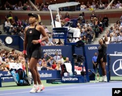 Serena Williams talks with chair umpire Carlos Ramos during a match against Naomi Osaka, of Japan, in the women's final of the U.S. Open tennis tournament, Saturday, Sept. 8, 2018, in New York. (AP Photo/Andres Kudacki)