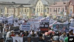 Afghan people take part in an anti U.S. rally organized by ' Afghanistan Hambastegi' party in Kabul, Afghanistan, Oct. 6, 2011.