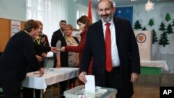 Acting Armenian Prime Minister Nikol Pashinian casts his ballot in a polling station during an early parliamentary election in Yerevan, Armenia, Sunday, Dec. 9, 2018. 