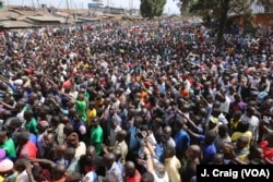 Crowd in the Nairobi slum of Kibera listen to Kenya's opposition leader Raila Odinga speak during a rally, Aug. 13, 2017.