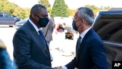 Secretary of Defense Lloyd Austin, left, greets NATO Secretary General Jens Stoltenberg upon his arrival at the Pentagon, Oct. 4, 2021.