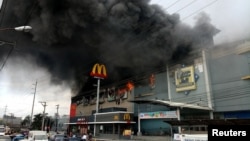 Smoke billows from a shopping mall fire in Davao City, the Philippines, Dec. 23, 2017, in a photo obtained from social media. (Yas D. Ocampo/via Reuters)