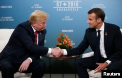 FILE - U.S. President Donald Trump shakes hands with France's President Emmanuel Macron during a bilateral meeting at the G-7 Summit in in Charlevoix, Quebec, Canada, June 8, 2018.