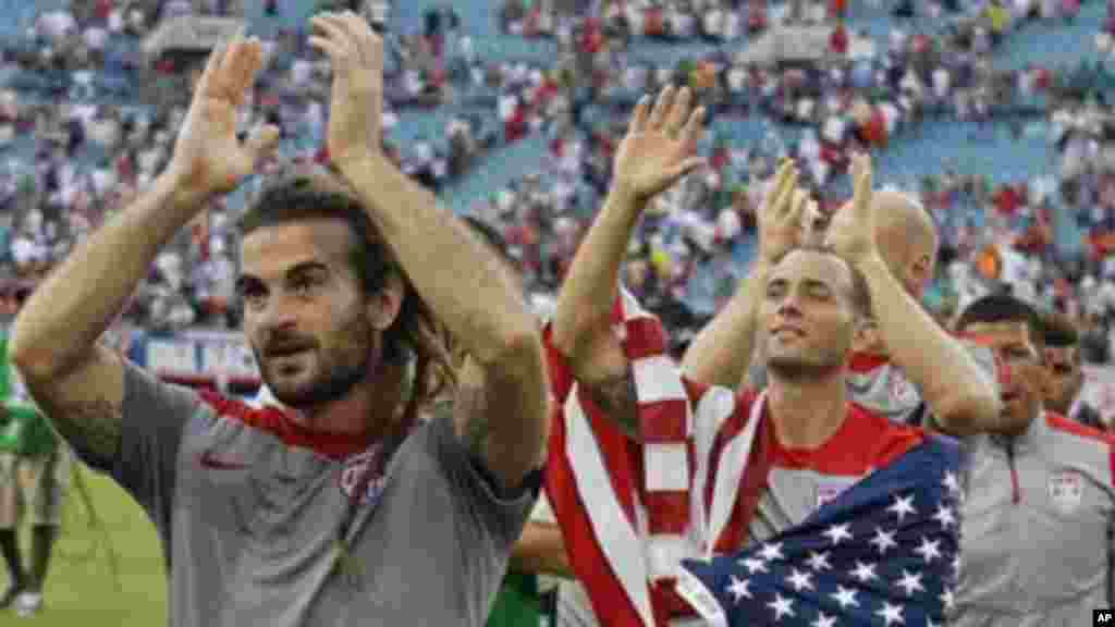 United States's Kyle Beckerman, Brad Davis, and other team members applaud fans after defeating Nigeria 2-1.