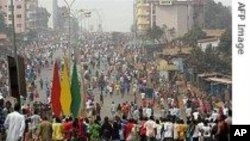 People gather at the site of an explosion at Sabon gari in Kano, Nigeria. Tuesday, July. 30, 2013. 