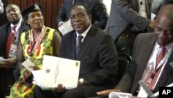 FILE: Emmerson Mnangagwa, center, is seen at ZANU-PF headquarters in Harare, Zimbabwe, Dec, 10, 2014. 