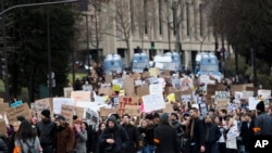 People hold placards during a gathering to protest U.S. President Donald Trump's recent travel ban to the U.S. in Paris, Feb. 4, 2017.