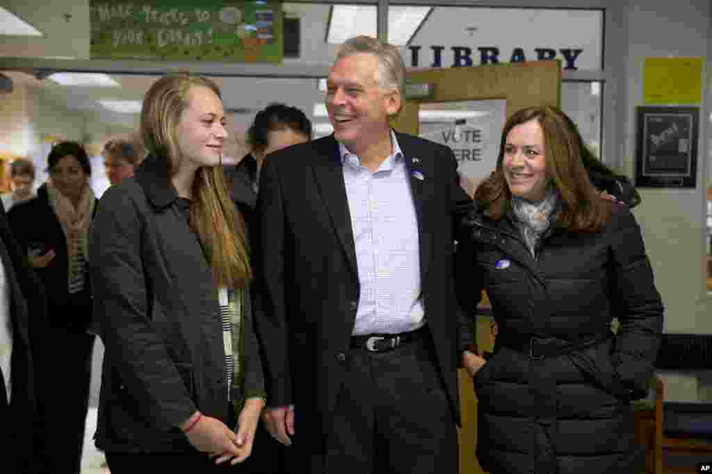 Virginia Democratic gubernatorial candidate Terry McAuliffe leaves Spring Hill Elementary School after voting, accompanied by his daughter Mary, left, and wife Dorothy on election day in McLean, Va., Nov. 5, 2013.