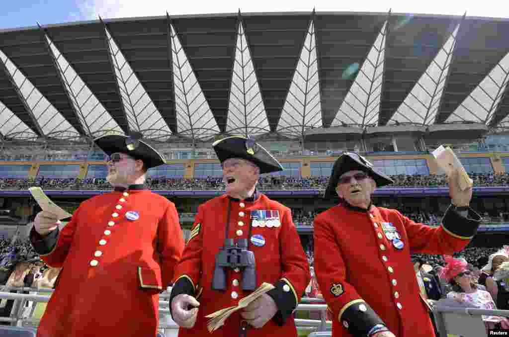 Chelsea Pensioners react on the fourth day of the Ascot horse racing festival at Ascot in southern England.
