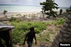 Myrlande Nazaire walks outside her residence in Port-Salut, Haiti, May 6, 2017. Myrlande says that one of her children was fathered by a U.N. peacekeeper. The paternity and child support issue is another awkward legacy of the 13-year U.N. mission, known as MINUSTAH, which is winding up in October.