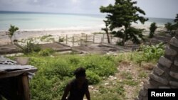 FILE - Myrlande Nazaire walks outside her residence in Port-Salut, Haiti, May 6, 2017. Myrlande says that one of her children was fathered by a U.N. peacekeeper. 