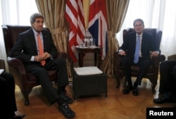 U.S. Secretary of State John Kerry (L) meets with British Foreign Secretary Philip Hammond at a hotel where the Iran nuclear talks meetings are being held in Vienna, Austria, July 2, 2015.