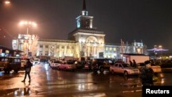 Interior Ministry members stand guard in front of the train station where a bomber detonated explosives in Volgograd, Dec. 29, 2013. 