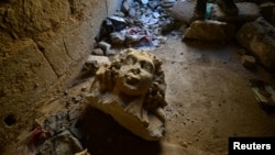 A destroyed artifact is seen at the ancient city of Hatra, south of Mosul, Iraq, April 27, 2017.