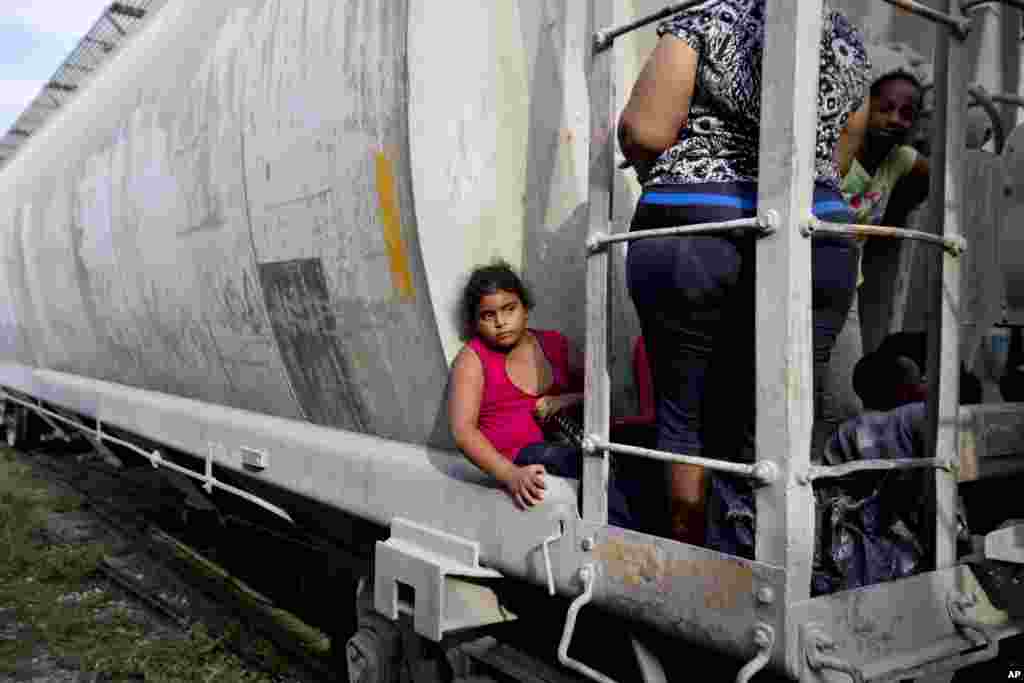A young migrant girl waits for a freight train&nbsp;in Ixtepec, Mexico, to depart to the U.S. border, July 12, 2014. The number of unaccompanied minors detained on the U.S. border has more than tripled since 2011.