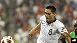 United States' Clint Dempsey (8) holds off a challenge by a Guadeloupe player during their CONCACAF Gold Cup match at Livestrong Stadium in Kansas City, Kansas June 14, 2011