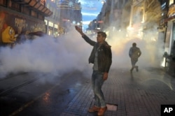 Police use teargas to disperse people protesting the killing of Tahir Elci, a prominent lawyer and human rights defender, who faced a prison term on charges of supporting Kurdish rebels, in Istanbul, Turkey, Nov. 28, 2015.