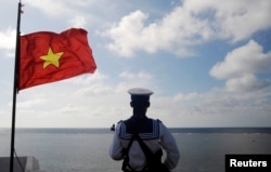 FILE - A Vietnamese naval soldier stands quard at Thuyen Chai island in the Spratly archipelago.