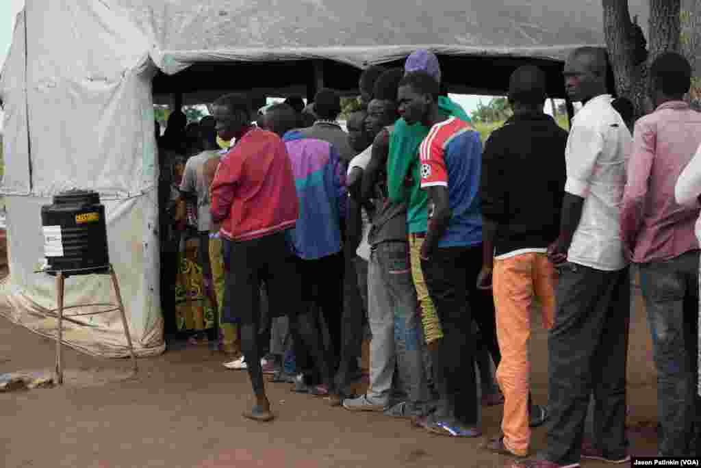 South Sudanese refugees line up for registration in Uganda.